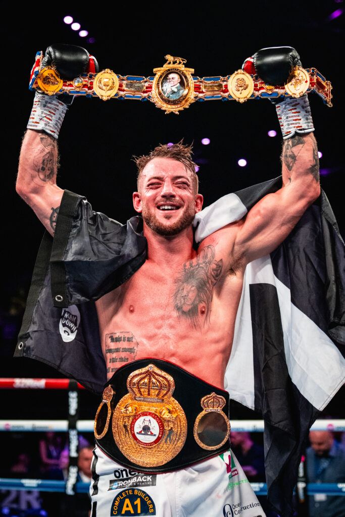 Image Of Brad Pauls Holding The British Title High After Defeating Nathan Heaney